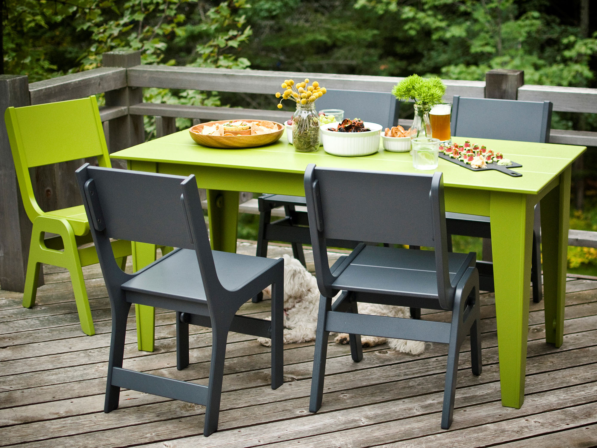Grey and green outdoor chairs around green outdoor dining table